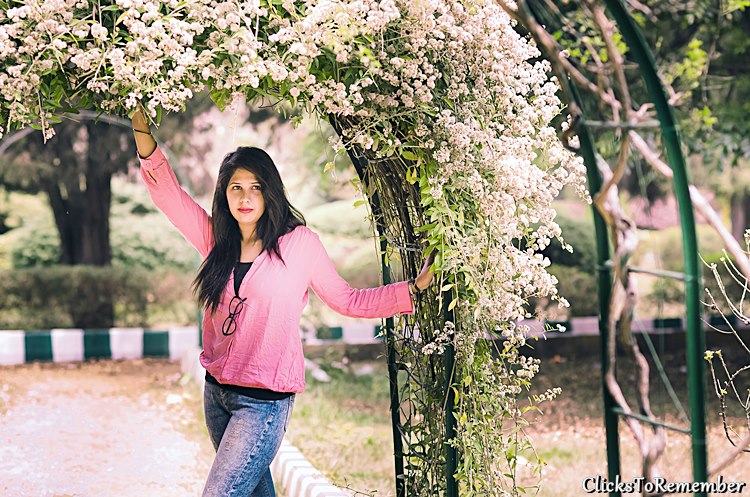 Beautiful model standing near flowering creepers Outdoor Model Photography in Bangalore