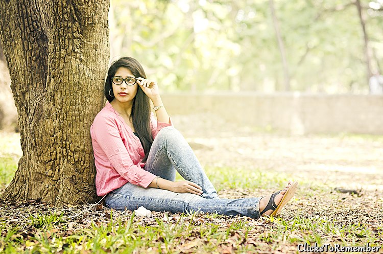 Model sitting on the ground leaning over a tree Outdoor Model Photography in Bangalore