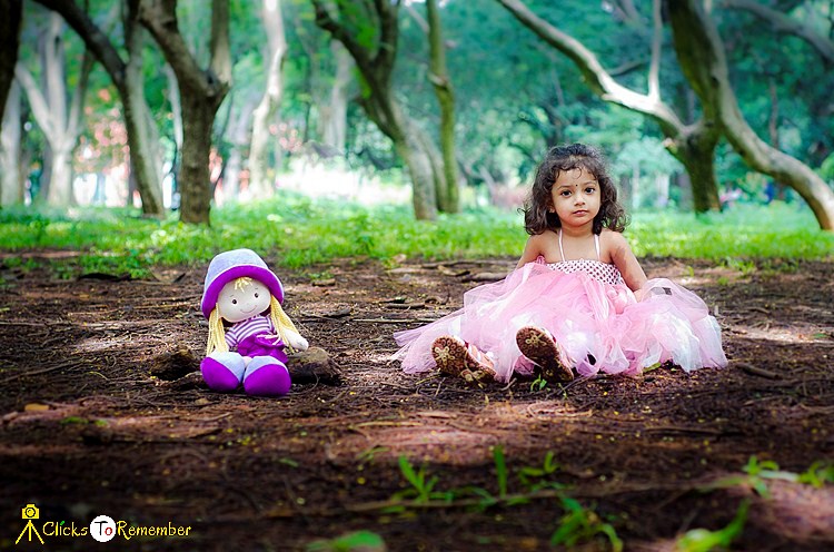 baby girl playing with her doll Kids Photography in India